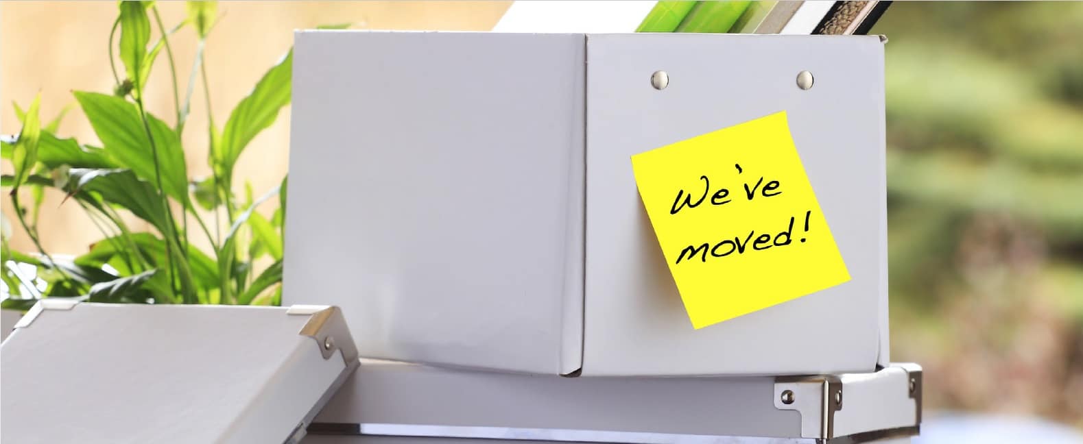 Office box with a sticky note saying we’ve moved illustrates a Commercial Real Estate Group of Tucson blog article.