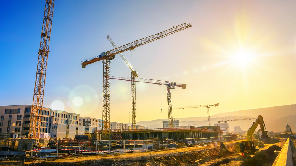 Large,Construction,Site,Including,Several,Cranes,Working,On,A,Building